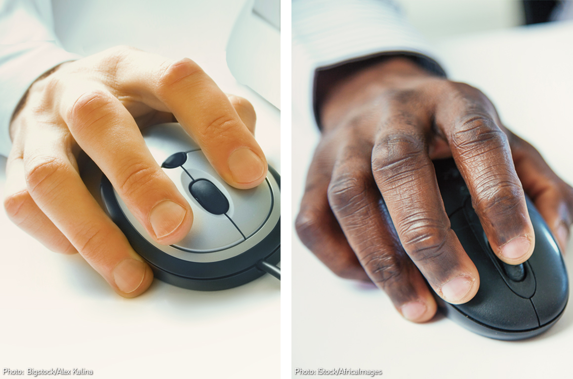 A white hand on a computer mouse side by side with a black hand on a computer mouse