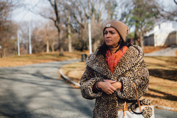 Linda Dominguez looks ahead, in the middle of a park. 